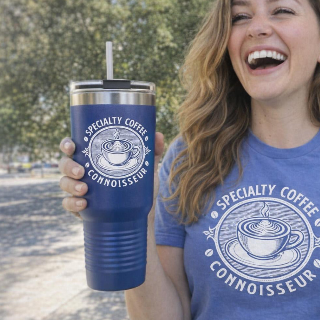 Woman wearing a blue t-shirt with 'Specialty Coffee Connoisseur' design, holding a matching blue tumbler.